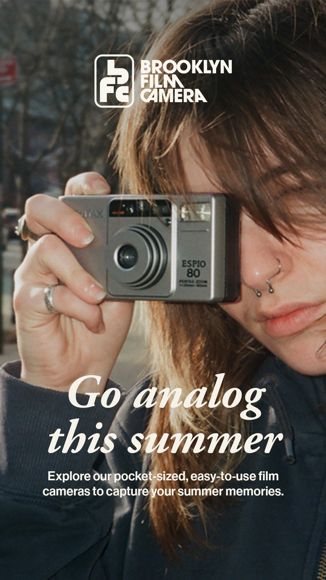 Brooklyn Film Camera Go analog this summer advertisement with a person holding a Pentax compact camera