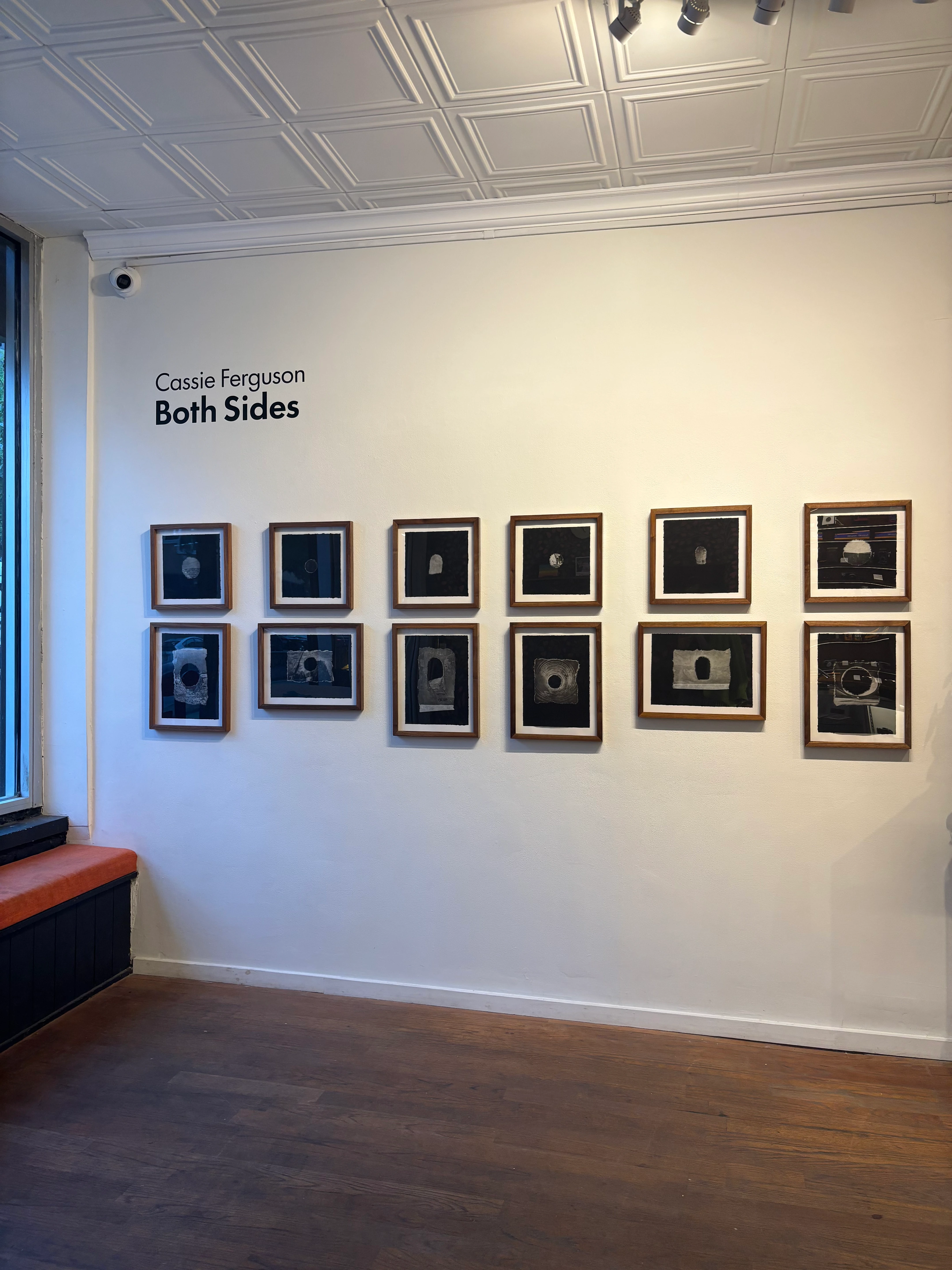 Two rows of framed artworks installed in the Brooklyn Film Camera gallery
