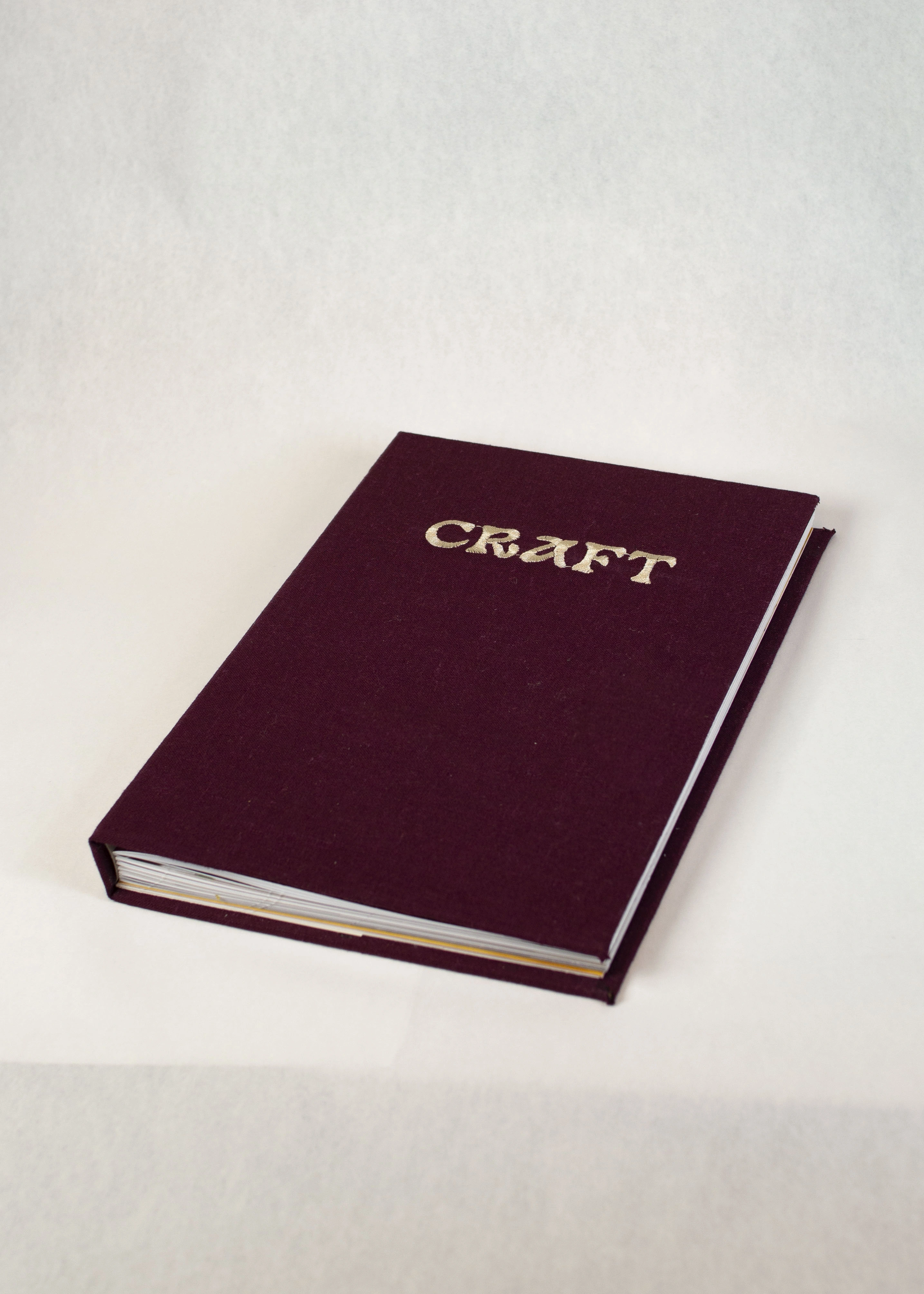 The burgundy cover of Craft, a hand-bound book